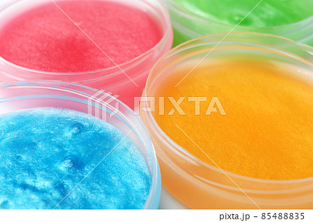 Colorful slimes in plastic containers, closeup. Antistress toy 85488835