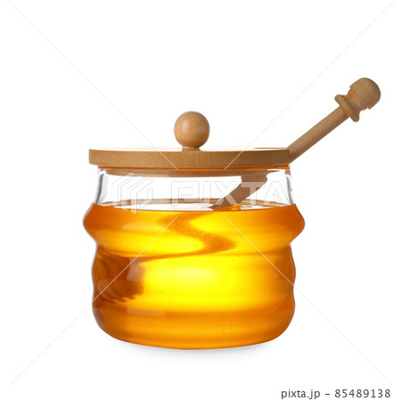 Jar with organic honey and dipper isolated on white Jar with organic honey and dipper isolated on white 85489138