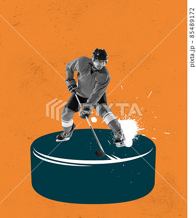 Creative design. Contemporary art collage. Man, professional hockey player standing on big puck with stick isolated over orange background Creative design. Contemporary art collage. Man, professional hockey player standing on big puck with stick isolated over orange background 85489172