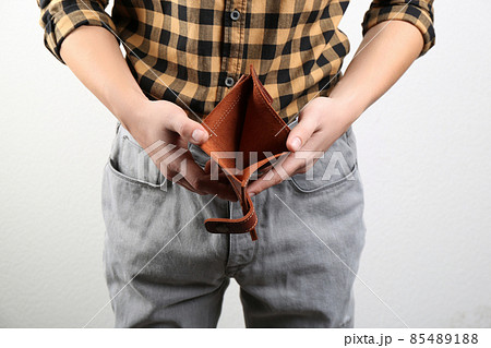 Man showing empty wallet on light background, closeup Man showing empty wallet on light background, closeup 85489188