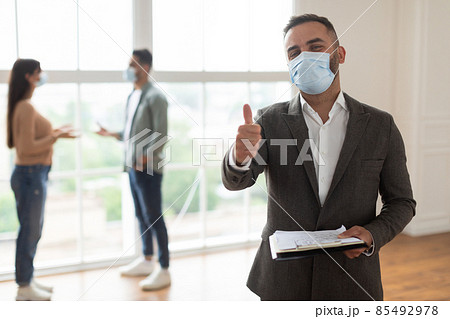 Portrait Of Real Estate Agent In Mask Showing Thumbs Up 85492978