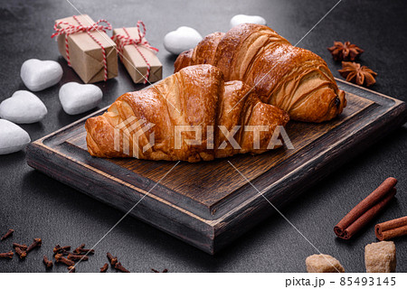Delicious fresh crispy croissants on a dark concrete background 85493145