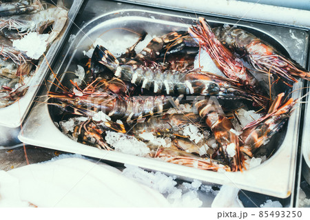 Close up of fresh raw prawn of shrimp in a stainless container in fresh seafood shop counter. Selective focus, copy space. Close up of fresh raw prawn of shrimp in a stainless container in fresh seafood shop counter. Selective focus, copy space. 85493250