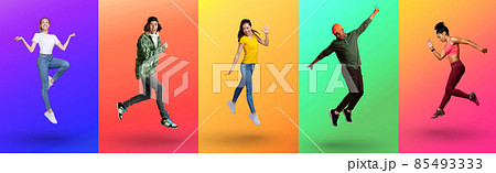 Cool young diverse people jumping up and expressing excitement on color neon studio backgrounds, full length 85493333