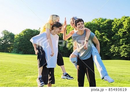 Teenage youth having fun in the park, happy laughing friends. 85493619