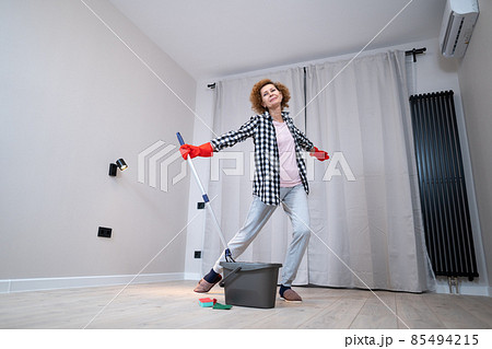 Jolly excited mature woman enjoying cleaning house, she dancing while washing floor. Happy elderly woman enjoying cleaning floors before moving to new apartment. Housework and housekeeping concept Jolly excited mature woman enjoying cleaning house, she dancing while washing floor. Happy elderly woman enjoying cleaning floors before moving to new apartment. Housework and housekeeping concept 85494215