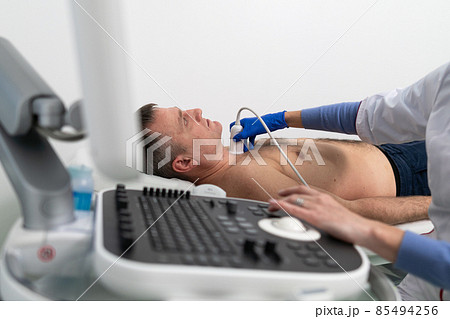 Doctor doing a doppler sonography a male patient in a cardiology clinic. Cardiologist performing an ultrasound examination at the cardiovascular hospital. Echocardiography procedure Doctor doing a doppler sonography a male patient in a cardiology clinic. Cardiologist performing an ultrasound examination at the cardiovascular hospital. Echocardiography procedure 85494256