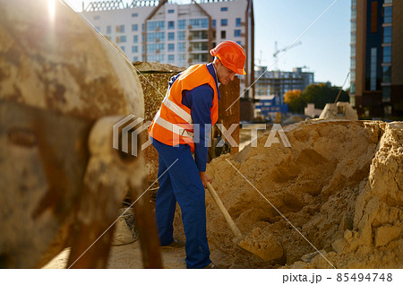 Male worker making concrete at construction site Male worker making concrete at construction site 85494748