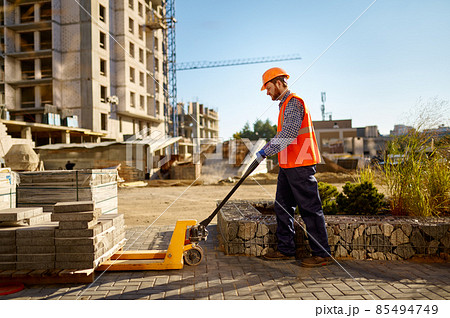 Male worker making concrete at construction site 85494749