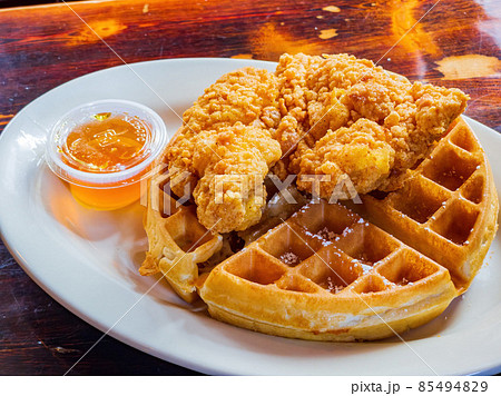 Close up shot of deep fried chicken with waffle 85494829