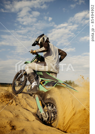 Extreme motocross rider riding on dirt track 85494902