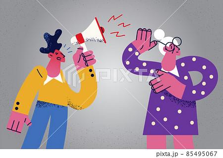 Man with loudspeaker shout to grandmother with hearing problem  85495067