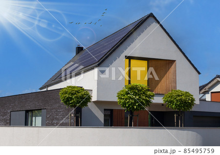 Modern house with solar panels and pool. Clear sky and ray sun. 85495759