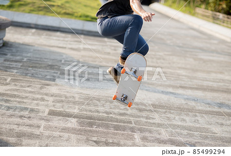 Skateboarder skateboarding outdoors in city 85499294