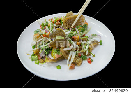 Die cut of Salad Crispy Gourami Fish with Spicy Seafood Sauce on black isolated. Die cut of Salad Crispy Gourami Fish with Spicy Seafood Sauce on black isolated. 85499820