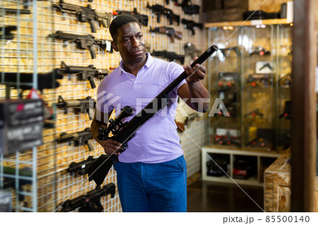 African-american man in airsoft shop African-american man in airsoft shop 85500140
