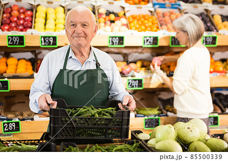 Old man greengrocer worker in salesroom Old man greengrocer worker in salesroom 85500339