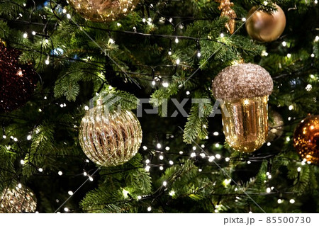 Golden, silver, purple, red, shiny ornate green Christmas tree and decorations 85500730