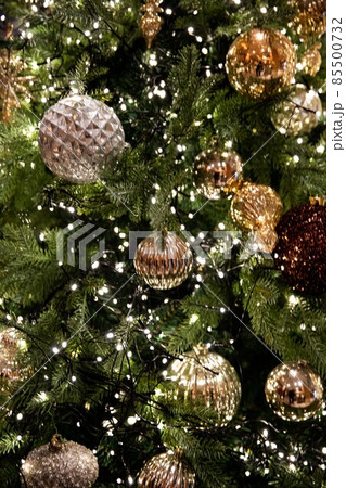 Golden, silver, purple, red, shiny ornate green Christmas tree and decorations 85500732
