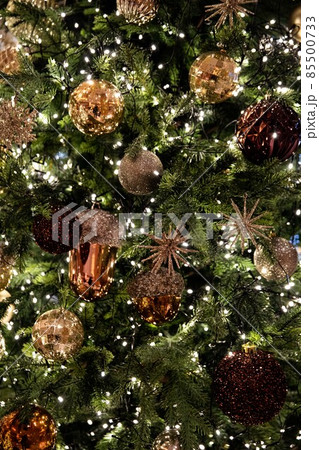 Golden, silver, purple, red, shiny ornate green Christmas tree and decorations 85500733