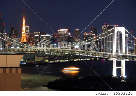 Tokyo's iconic Rainbow Bridge as seen at night from Odaiba with Tokyo Tower in the background Tokyo's iconic Rainbow Bridge as seen at night from Odaiba with Tokyo Tower in the background 85503226