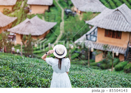 Happy tourist woman in white dress enjoy beautiful Tea garden.Traveler visiting in Ban Rak Thai village, Mae Hong Son, Thailand. travel, vacation and holiday concept Happy tourist woman in white dress enjoy beautiful Tea garden.Traveler visiting in Ban Rak Thai village, Mae Hong Son, Thailand. travel, vacation and holiday concept 85504143