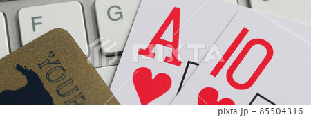 Playing cards bank credit card and computer keyboard on table. Playing cards bank credit card and computer keyboard on table. 85504316