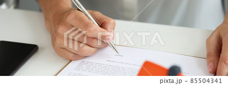 Woman signs home purchase agreement in office closeup 85504341