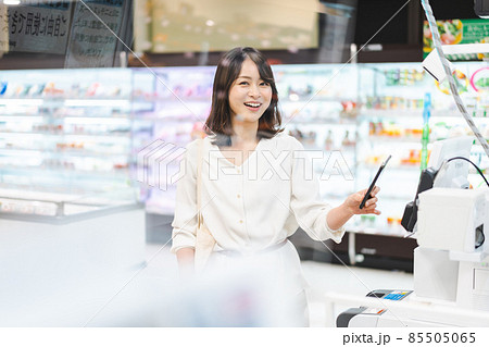 スーパーでスマホ決済を使う若い女性 スーパーでスマホ決済を使う若い女性 85505065