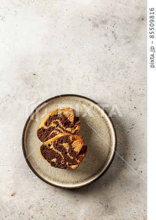 Two slices of zebra cake on a plate, top view, copy space, isolated Two slices of zebra cake on a plate, top view, copy space, isolated 85509816