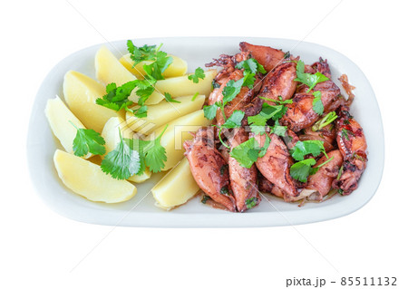 Traditional portuguese dish baked potato with fried or grilled squid on plate on isolated white background. Traditional portuguese dish baked potato with fried or grilled squid on plate on isolated white background. 85511132