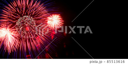 Flash of red and white fireworks on background black sky. Concept of holiday. Close-up, banner, copy space. 85513616