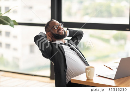 African American man leaning back taking break African American man leaning back taking break 85516250