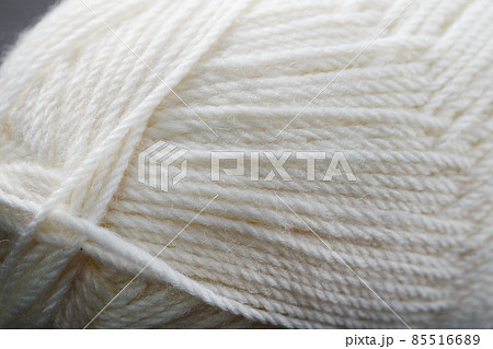 White threads of natural wool close-up in full screen White threads of natural wool close-up in full screen 85516689