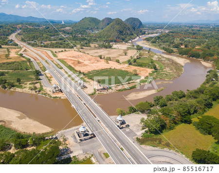 Beautiful aerial view of the new bridge build for crossing Kok river in Doi Hang subdistrict of Chiang Rai province of Thailand. Beautiful view of the nature from drone.   85516717