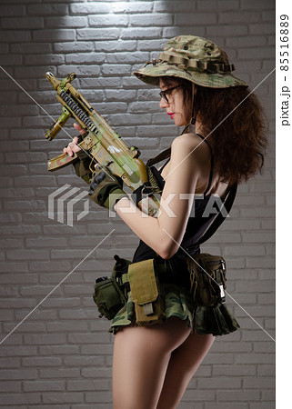 sexy girl military soldier in short skirt with automatic rifle for airsoft 85516889