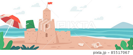 Sand Castle on Sea Beach with Plastic Kids Bucket, Umbrella and Seashells. Summer Travel, Vacation, Sandcastle on Ocean 85517067