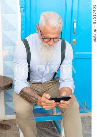 Senior man with a phone Senior man with a phone 85517401