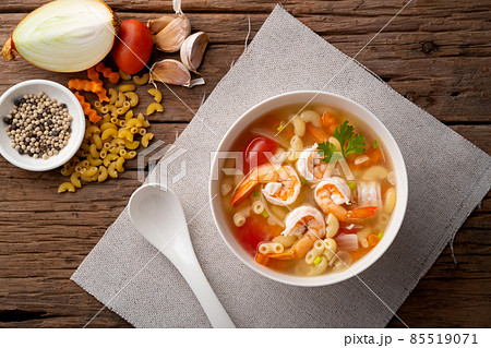 Macaroni Soup with Shrimps ,tomato ,carrots and onion on white bowl.Top view Macaroni Soup with Shrimps ,tomato ,carrots and onion on white bowl.Top view 85519071