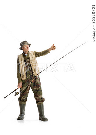 Portrait of young man, professional fisherman with fishing rod, spinning and equipment going to river isolated over white studio background Portrait of young man, professional fisherman with fishing rod, spinning and equipment going to river isolated over white studio background 85520701