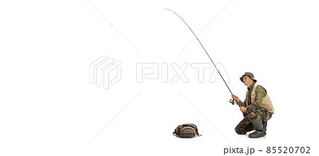 Portrait of young man, professional fisherman with fishing rod, spinning and equipment going to river isolated over white studio background Portrait of young man, professional fisherman with fishing rod, spinning and equipment going to river isolated over white studio background 85520702
