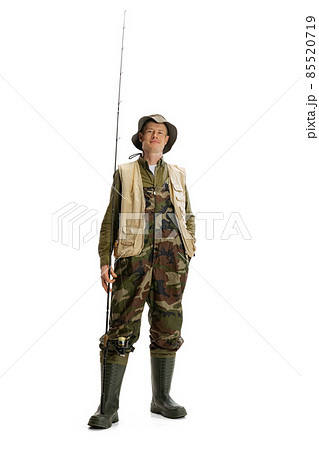 Portrait of young man, professional fisherman with fishing rod, spinning and equipment going to river isolated over white studio background 85520719