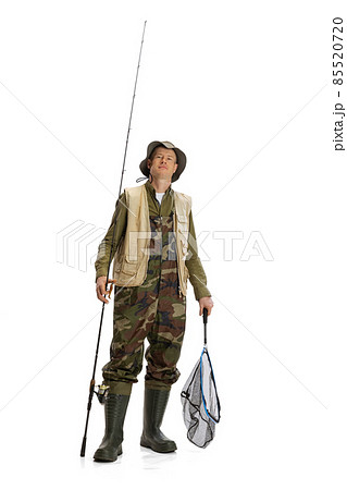 Portrait of young man, professional fisherman with fishing rod, spinning and equipment going to river isolated over white studio background Portrait of young man, professional fisherman with fishing rod, spinning and equipment going to river isolated over white studio background 85520720