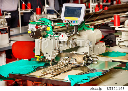 Modern sewing equipment in a sewing factory, a sewing machine with programmable functions close-up. Modern sewing equipment in a sewing factory, a sewing machine with programmable functions close-up. 85521163