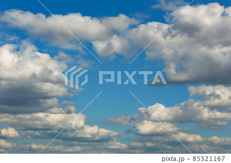 Lush white clouds float in height to form a clear window of blue sky. 85521167