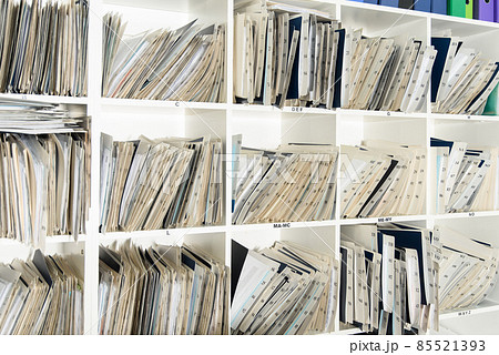 Shelves are full with folders and files of medical record, patient information Shelves are full with folders and files of medical record, patient information 85521393
