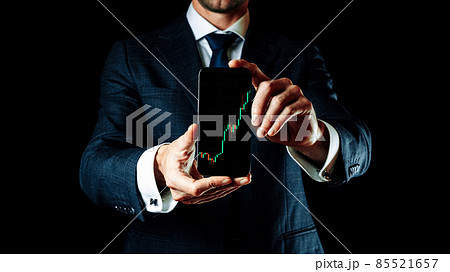 Sell and buy. Investment business technology app on digital screen in businessman hands. Finance application for sell, buy and analysis profit dividend statistics. Candlestick chart banner. 85521657