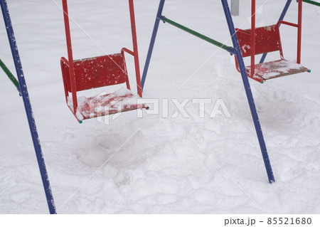 Swing seat covered with snow, winter season 85521680