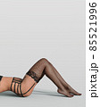 Bum and legs of sexy woman in black garter belt, stockings standing on white background 85521996