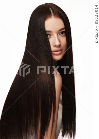 Beautiful brown-haired girl with a perfectly smooth hair, and classic make-up. Beauty face and hair. Beautiful brown-haired girl with a perfectly smooth hair, and classic make-up. Beauty face and hair. 85522014